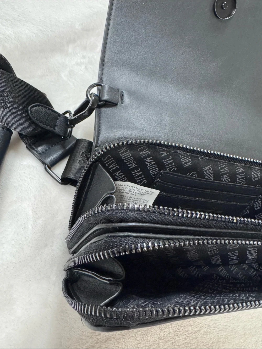 Steve Madden Black Embossed Logo Crossbody Bag.